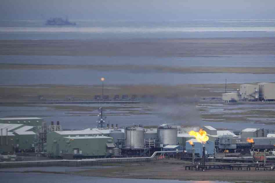 An oil facility burns excess gas on the western side of the Prudhoe Bay oil field. It is one of many similar industrial structures stretching for more than 60 miles along the coastal planes. Nearby, the native town of Nuiqsut is suffering from bad air quality as a result of the pollutants.