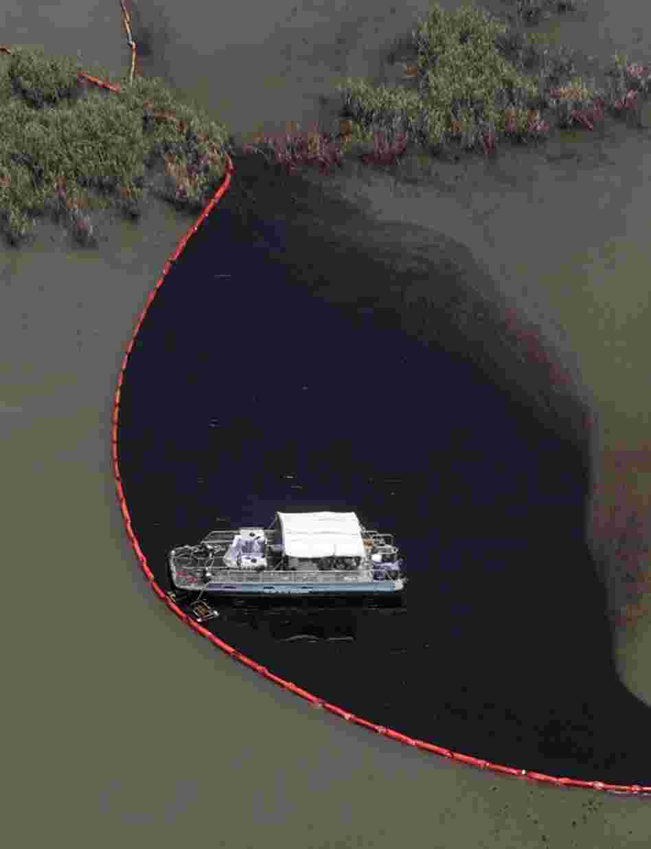 Workers clean up oil in Pass a Loutre, La.  The latest attempt to plug the leak was unsuccessful. 