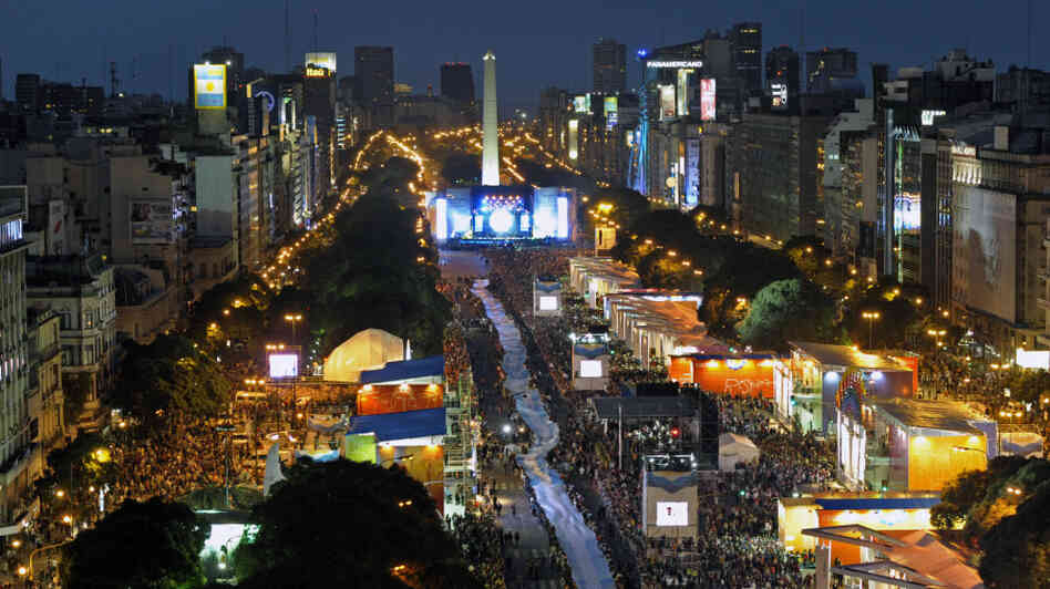 People hold a huge Argentine flag along People hold a huge Argentine flag along