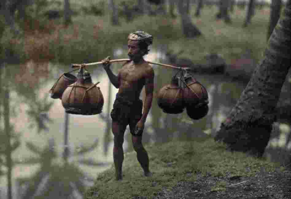 Porter with wine gourds, Bali, 1928 