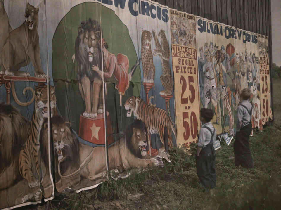 Children read the coming attractions of a traveling circus, 1931 Children read the coming attractions of a traveling circus, 1931