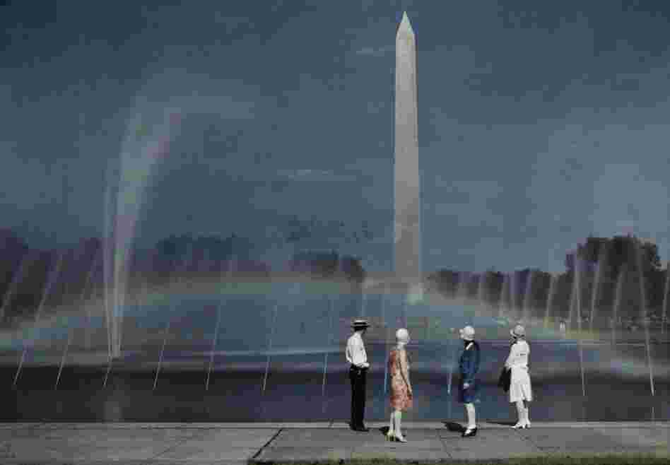 Tourists admire the Washington Monument in Washington, D.C., published 1935 