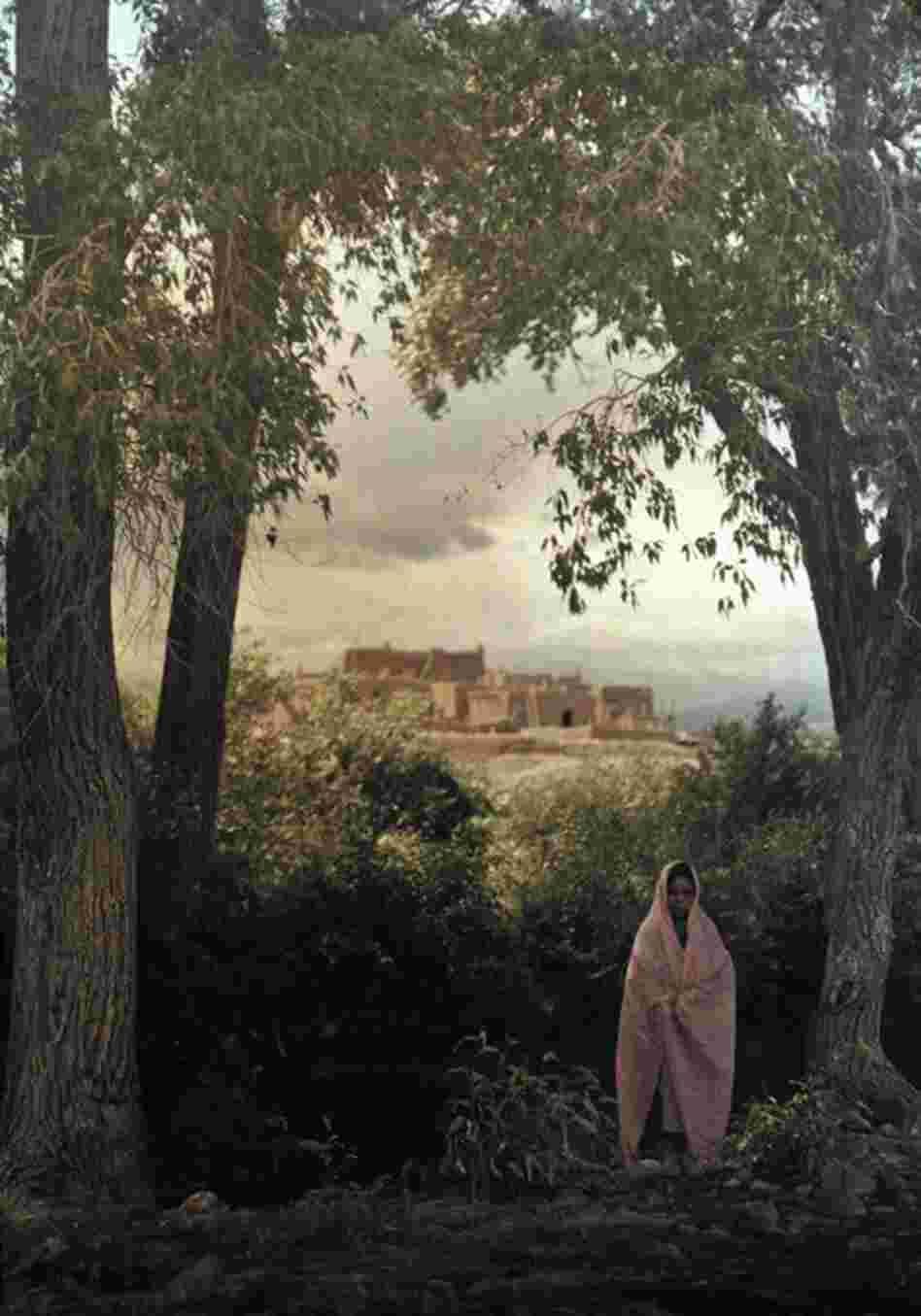 A woman poses outside the South Pueblo in Taos, New Mexico, circa 1914 