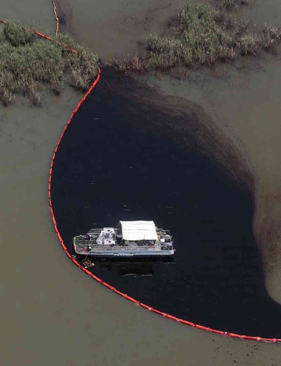 Workers clean up oil in Pass a Loutre, La.  The latest attempt to plug the leak was unsuccessful. 