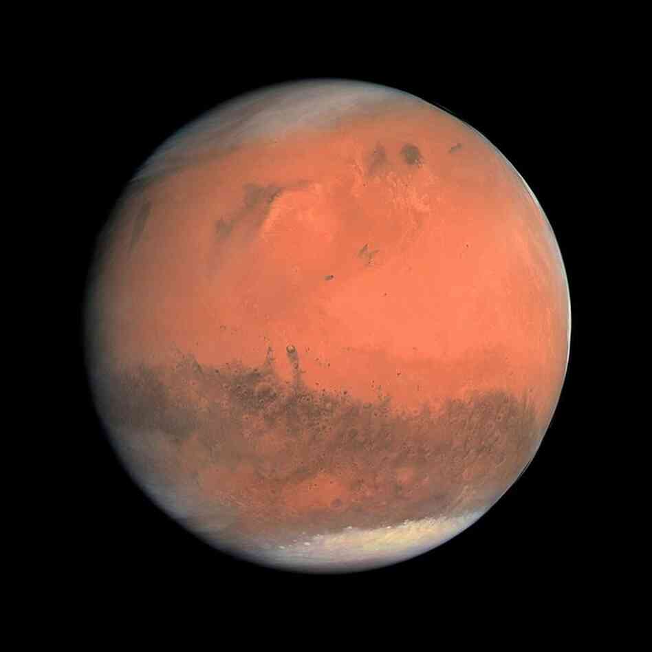 Southern Spring On MarsAt a certain time of the Martian year, a large fraction of the planet's atmosphere evaporates from the southern polar cap and migrates to the northern polar cap. Clouds are visible at the north polar cap and at the planetary horizon to the right. European Space Agency's Rosetta spacecraft, Feb. 24, 2007.