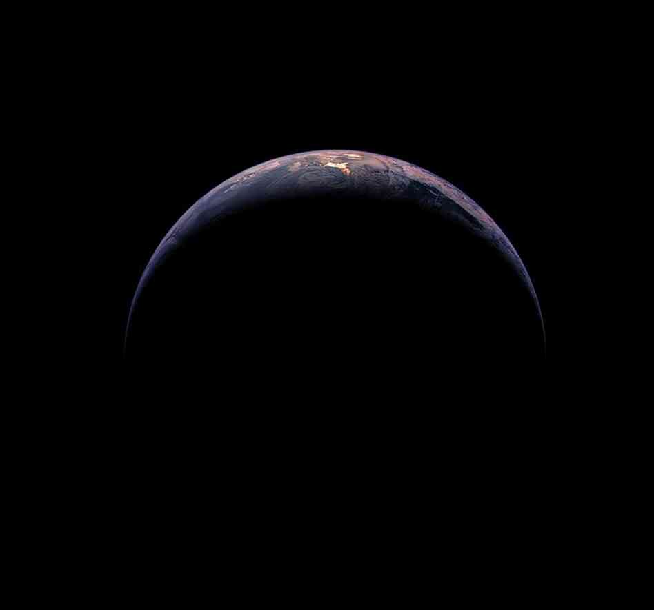 The Crescent EarthReflected sunlight glows through the clouds over the far South Pacific, where part of South America and Antarctica are visible. This image was taken from 217,500 miles away, or almost the distance to the moon. Rosetta, Nov. 13, 2009