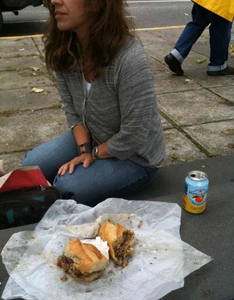 Rita stops eating her sandwich. Rita stops eating her sandwich.