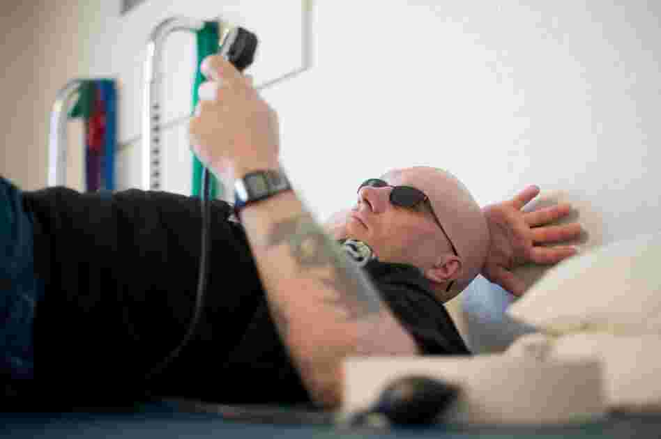 William Fraas checks a pressure gauge during exercises for his lower back. He can no longer drive or remember simple lists of jobs to do around the house. "When someone has a brain injury, you can't see it, but it's still serious," he says.