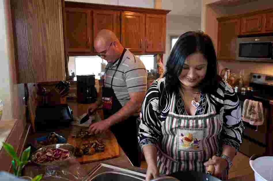 Victor Medina prepares dinner with his wife, Roxana Delgado, at their home in El Paso. Delgado was instrumental in fighting to get care for Medina, who now is improving after starting treatment at Mentis.