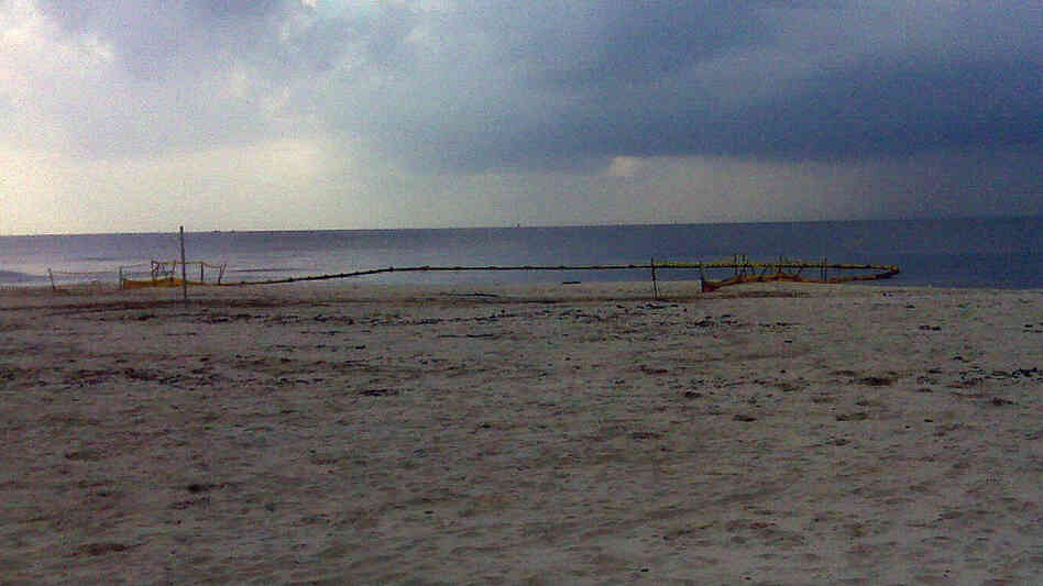 A Pascagoula beach with the boom around one of the drainage outflows A Pascagoula beach with the boom around one of the drainage outflows