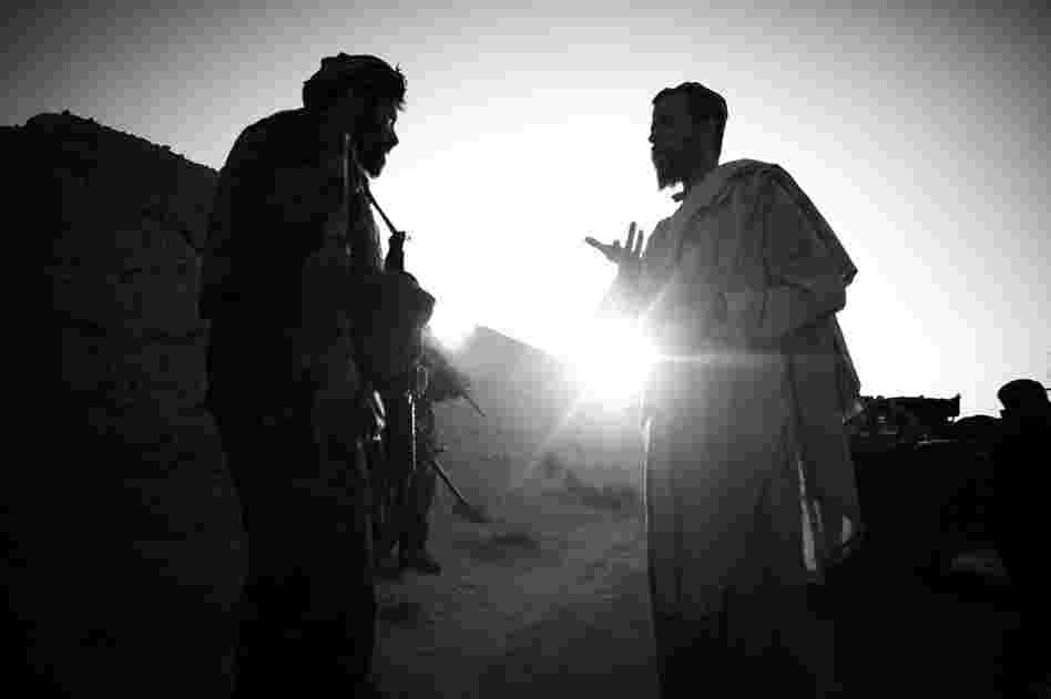 Capt. Dost (left) talks with a local resident in Ezabad in Afghanistan's Kandahar province. While American efforts may fall on deaf ears, Afghan villagers have been inclined to facilitate the efforts of the Afghan special forces.