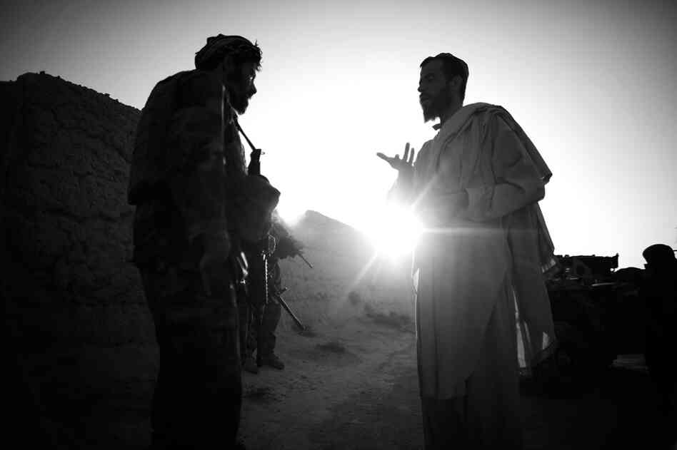 Capt. Dost (left) talks with a local resident in Ezabad in Afghanistan's Kandahar province. While American efforts may fall on deaf ears, Afghan villagers have been inclined to facilitate the efforts of the Afghan special forces.