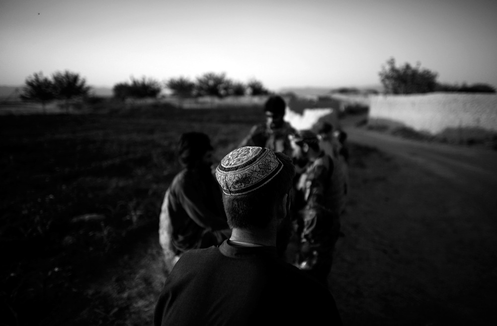 American and Afghan forces stop to talk with villagers on the road outside Ezabad.