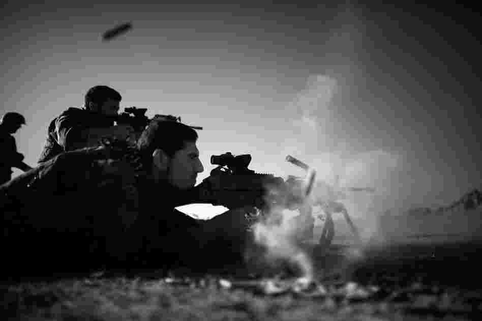American and Afghan soldiers fire side by side during a shooting exercise in the desert near Ezabad. When not on regular patrols, the Afghan and U.S. special forces are training for the next mission.