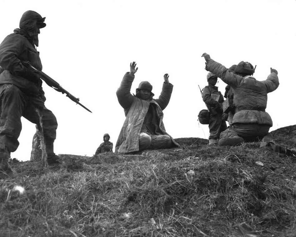 Men of the 1st Marine Division capture Chinese soldiers during fighting on the central Korean front at Hoengsong in March 1951. 