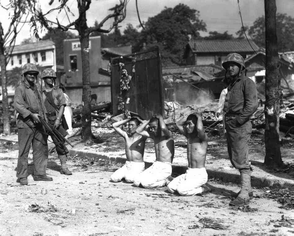 U.S. Marines guard three captured North Koreans. 