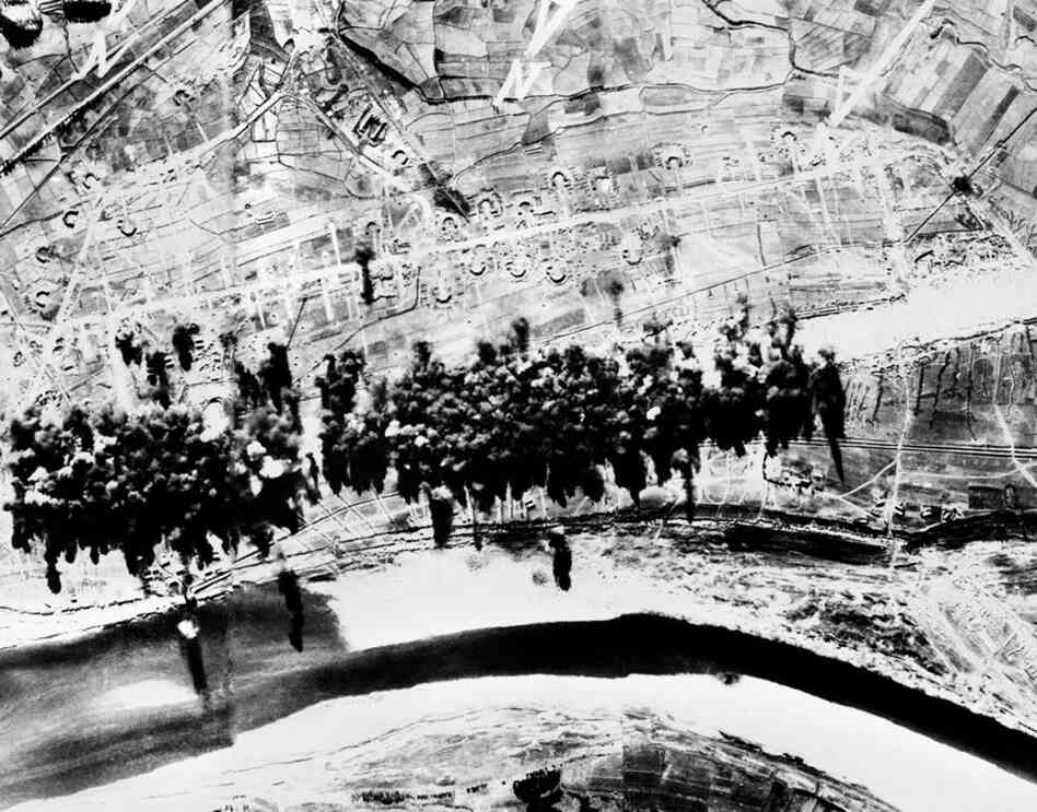 Aerial photographs taken during a bombing run showing the destruction of a North Korean airfield that had been near completion at Saamcham. 
