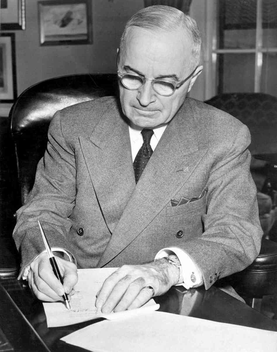 President Harry Truman signs a proclamation declaring a national emergency on December 16, 1950. 