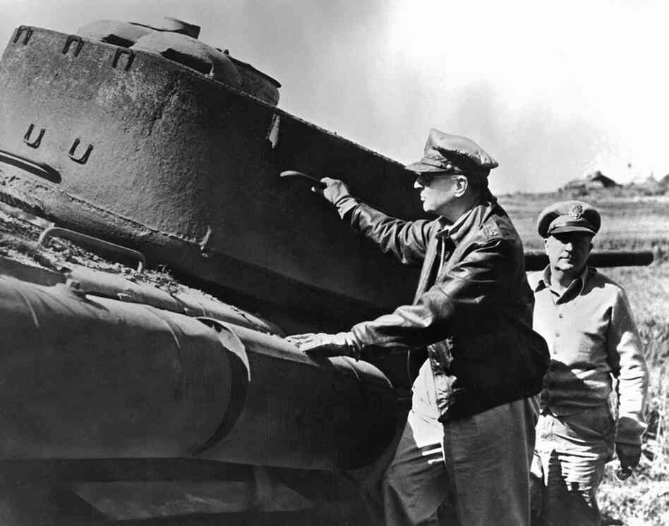 General of the Army Douglas MacArthur, commanding general for the U.N. forces aiding the Republic of Korea, inspects a North Korean tank destroyed during the Inchon landing. 