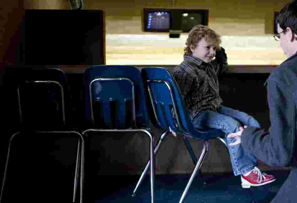 Noah, 6, receives help tying his bowling shoes from his father, Nathan. Noah was born in 2004, but his parents didn't get married until 2009.