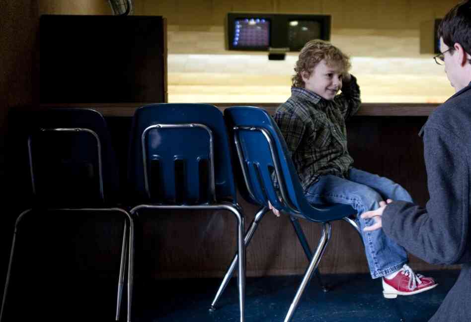 Noah, 6, receives help tying his bowling shoes from his father, Nathan. Noah was born in 2004, but his parents didn't get married until 2009.