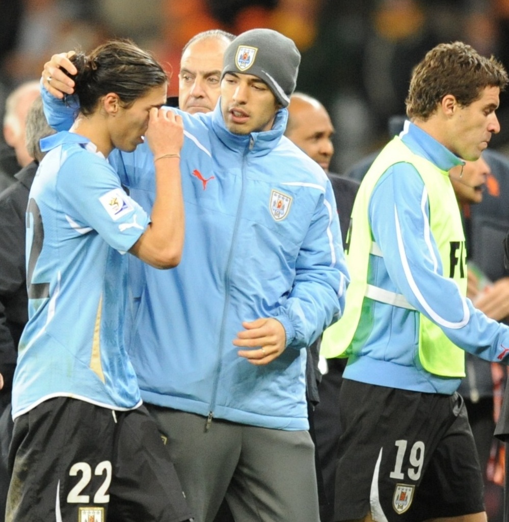 Uruguay's defender Martin Caceres (L) re