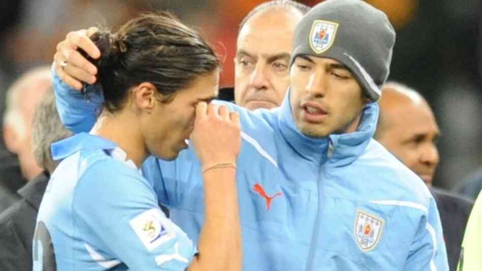Uruguay's defender Martin Caceres (L) re
