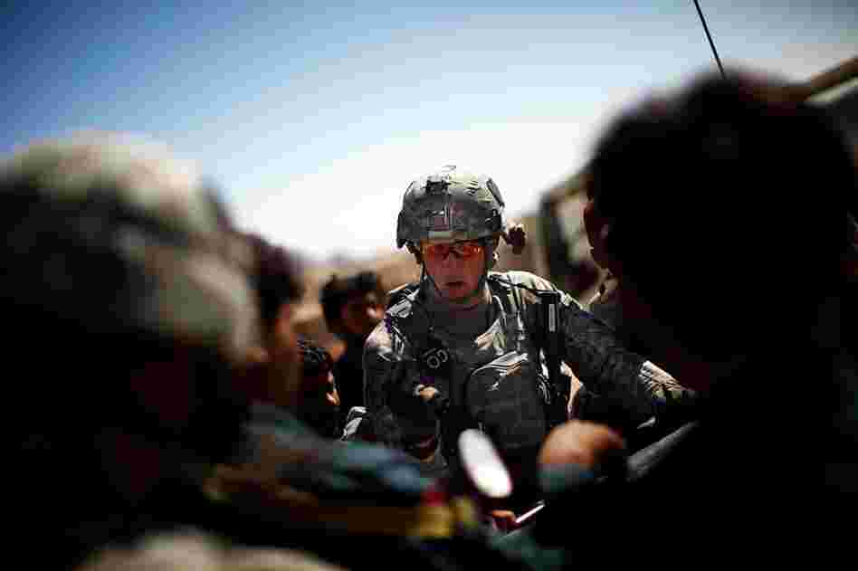 Capt. Nick Stout, commander of Alpha Company, readies his men and Afghan soldiers and police for a joint patrol to pursue the people responsible for throwing hand grenades at his patrols.