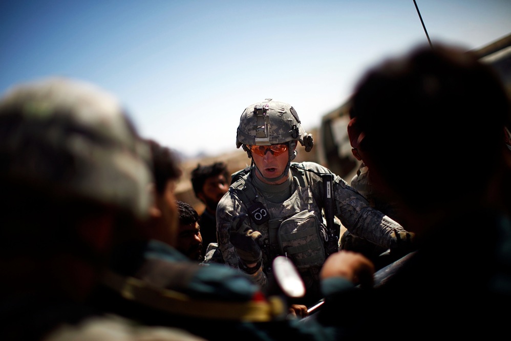 Capt. Nick Stout, commander of Alpha Company, readies his men and Afghan soldiers and police for a joint patrol to pursue the people responsible for throwing hand grenades at his patrols.