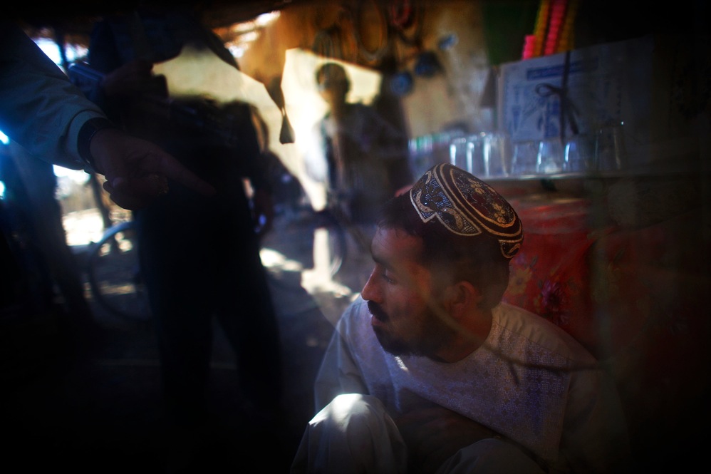 Karim Jan, the governor, points his finger in shame at a local shop owner he suspects of aiding the Taliban. The 101st Airborne Division's task is to bring security to a 16-mile long swath of lush orchards and fields north and west of the city of Kandahar. The Taliban live in the area, plan their operations and hide weapons here.