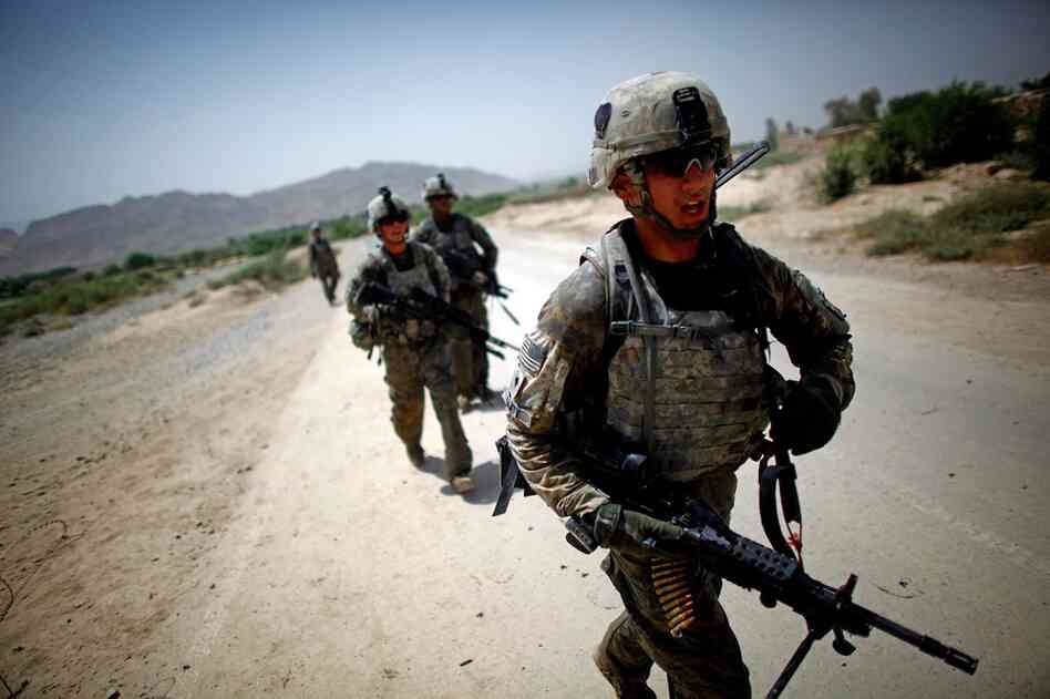 Saaty walks back to the combat outpost, exhausted from the gun battle in 115-degree heat.