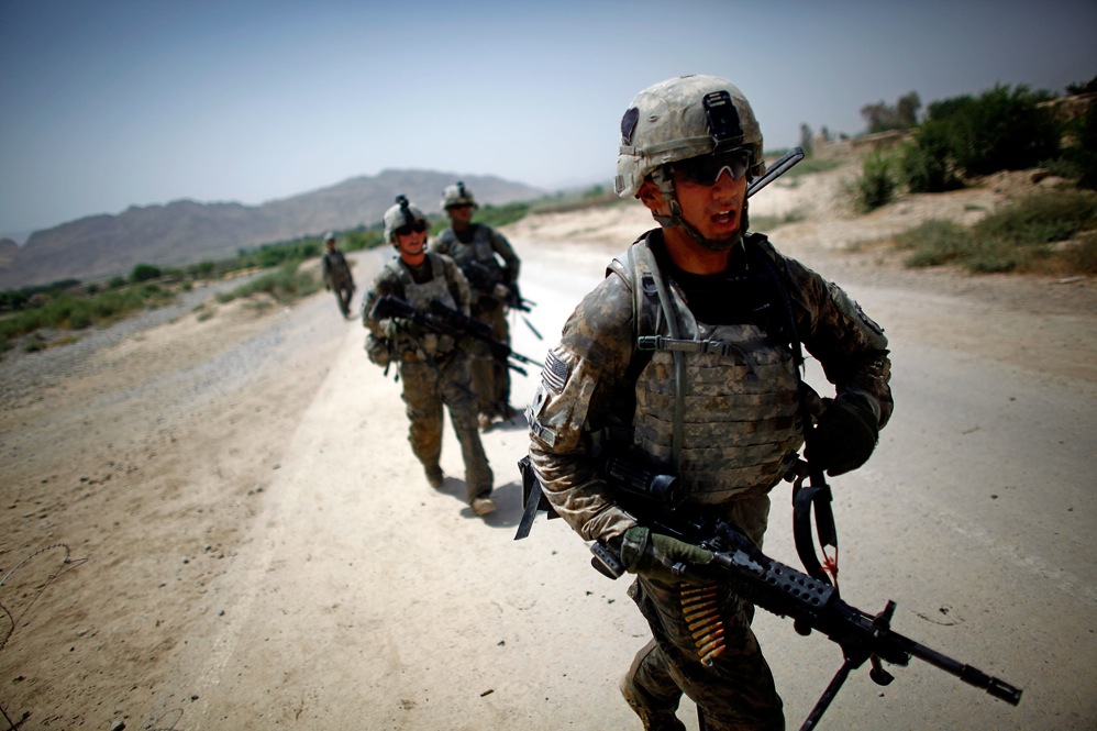 Saaty walks back to the combat outpost, exhausted from the gun battle in 115-degree heat.