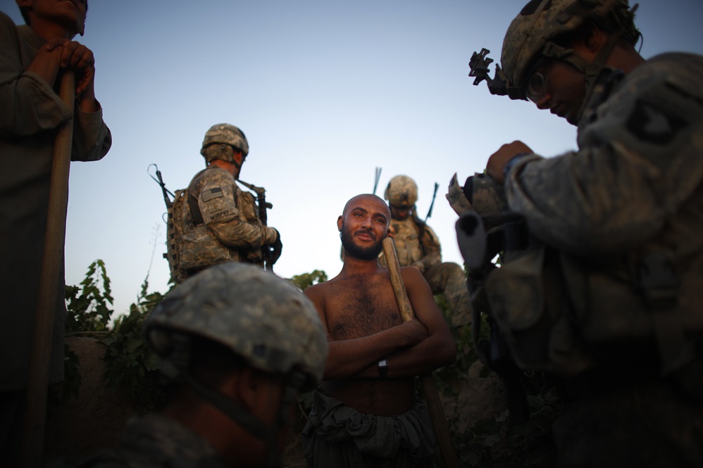 Soldiers stop to talk to a field worker. Many of the workers are not from this area, but brought in for the harvest of grapes -- making it even more difficult to sort out who is there to work and who has come to fight.