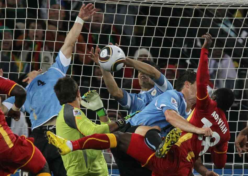 Uruguay's striker Luis Suarez (center) stops the ball with his hands, leading to a red card and a penalty kick for Ghana during quarterfinal action between Uruguay and Ghana. 