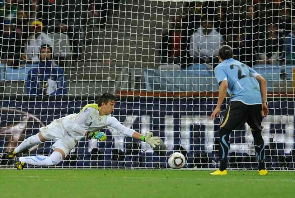 Uruguay's goalkeeper Fernando Muslera is beaten by Netherlands midfielder Wesley Sneijder (not shown) during their semifinal match. 