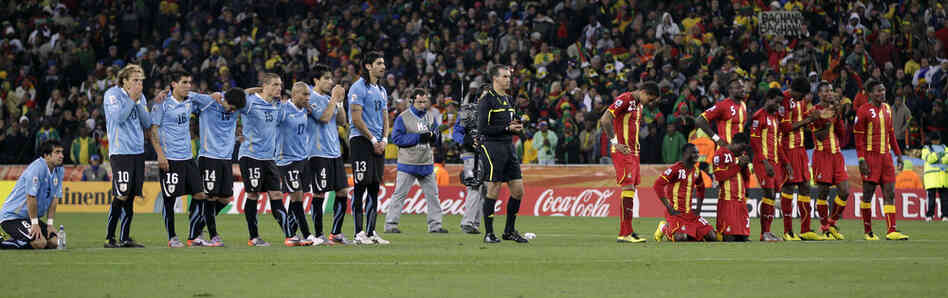 Players for Uruguay (left) and Ghana line up during the penalty shootout. Uruguay reached the World Cup semifinals for the first time since 1970 after beating Ghana 4-2 on penalty shots. 