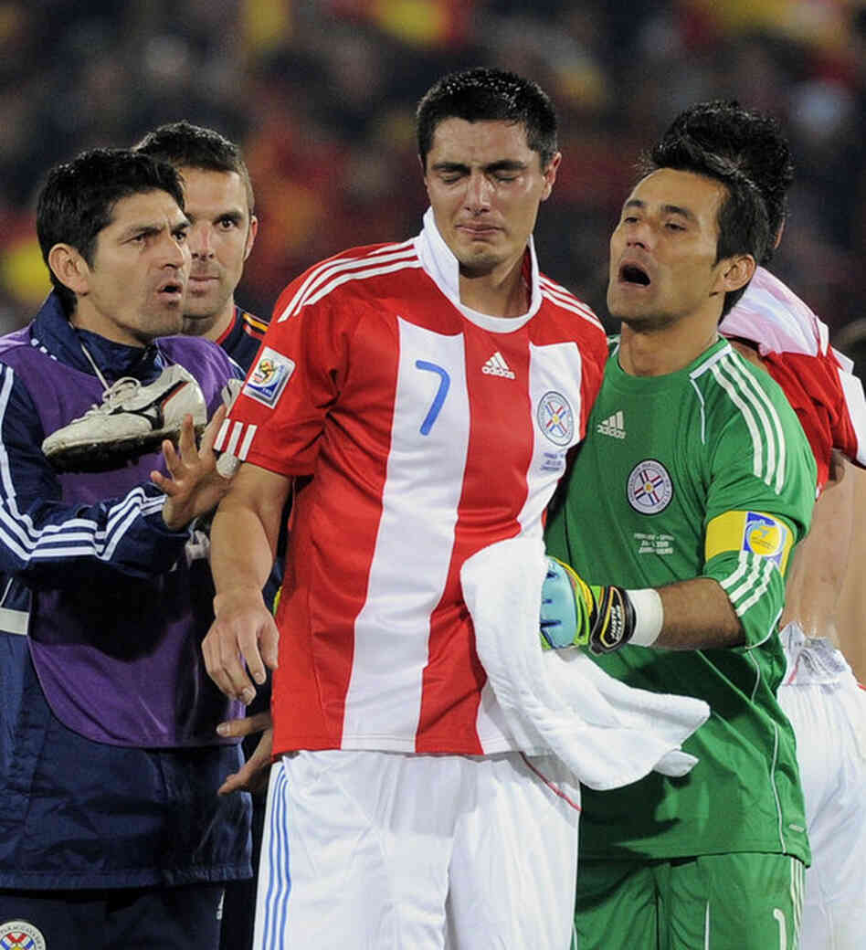 Paraguay's Oscar Cardozo is comforted by goalkeeper Justo Villar (right) following their 1-0 loss to Spain. 