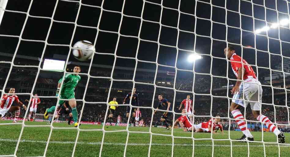 Spain's striker David Villa (fifth from right) scores a goal during the quarterfinal match with Paraguay. 
