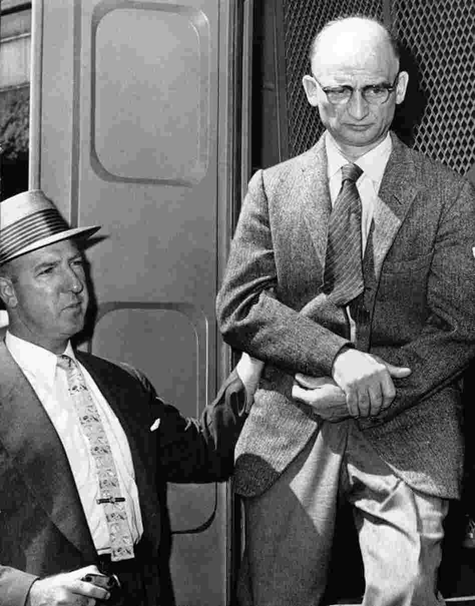 Alleged Russian spy Rudolf Abel (right) steps down from a patrol wagon in front of Brooklyn Federal Court in August 1957. He was due to appear in court on charges of espionage. Abel would later be swapped for Powers. 