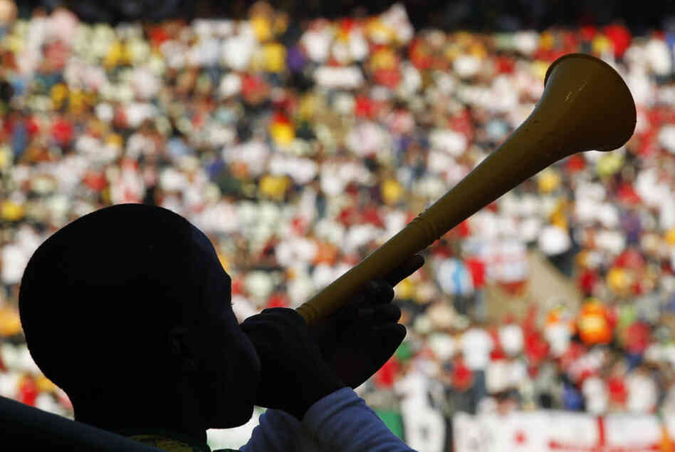 Soccer supporter blows a vuvuzela