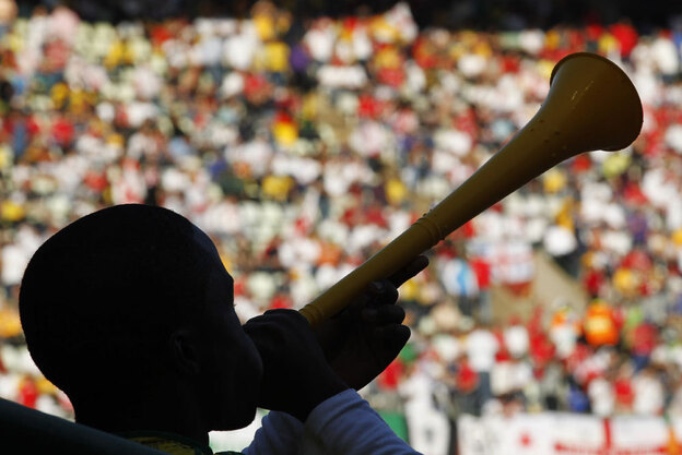 Soccer supporter blows a vuvuzela