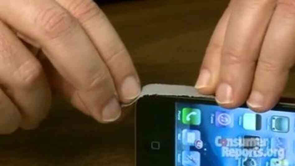 Placing duct tape on iPhone 4 Placing duct tape on iPhone 4