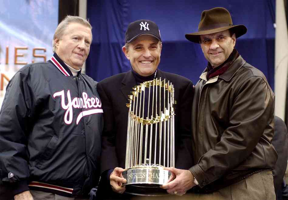Steinbrenner (from left), New York Mayor Rudolph Giuliani and Yankees manager Joe Torre hold the World Series trophy October 30, 2000, after the Yankees' victory parade in New York City. The Yankees won seven World Series titles under Steinbrenner's reign. 