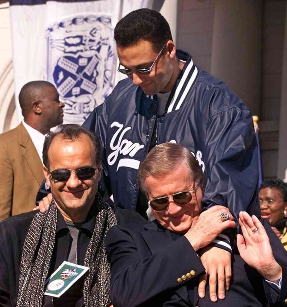 Yankees shortstop Derek Jeter greets manager Joe Torre (left) and Steinbrenner at the start of a rally honoring their 1999 World Series Championship. 
