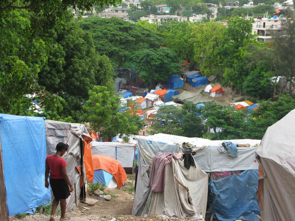 A woman walks down a path in the crowded Petionville Club camp in Port-au-Prince. 