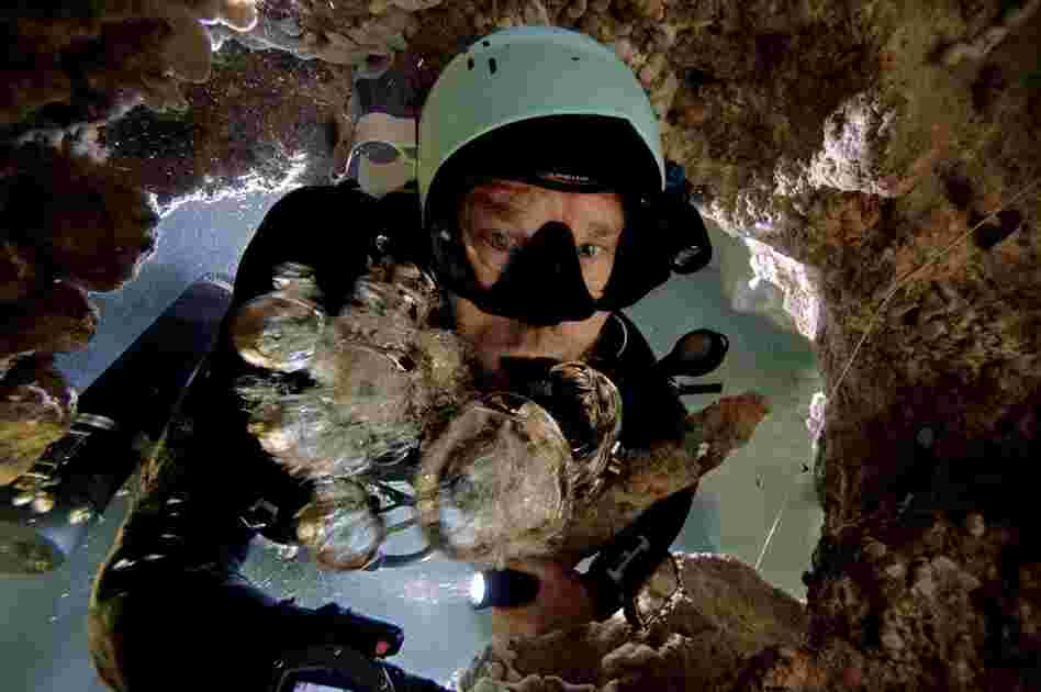 Kenny Broad fights to get to the surface, his air bubbles forced down by the current in a blue hole on Abaco.