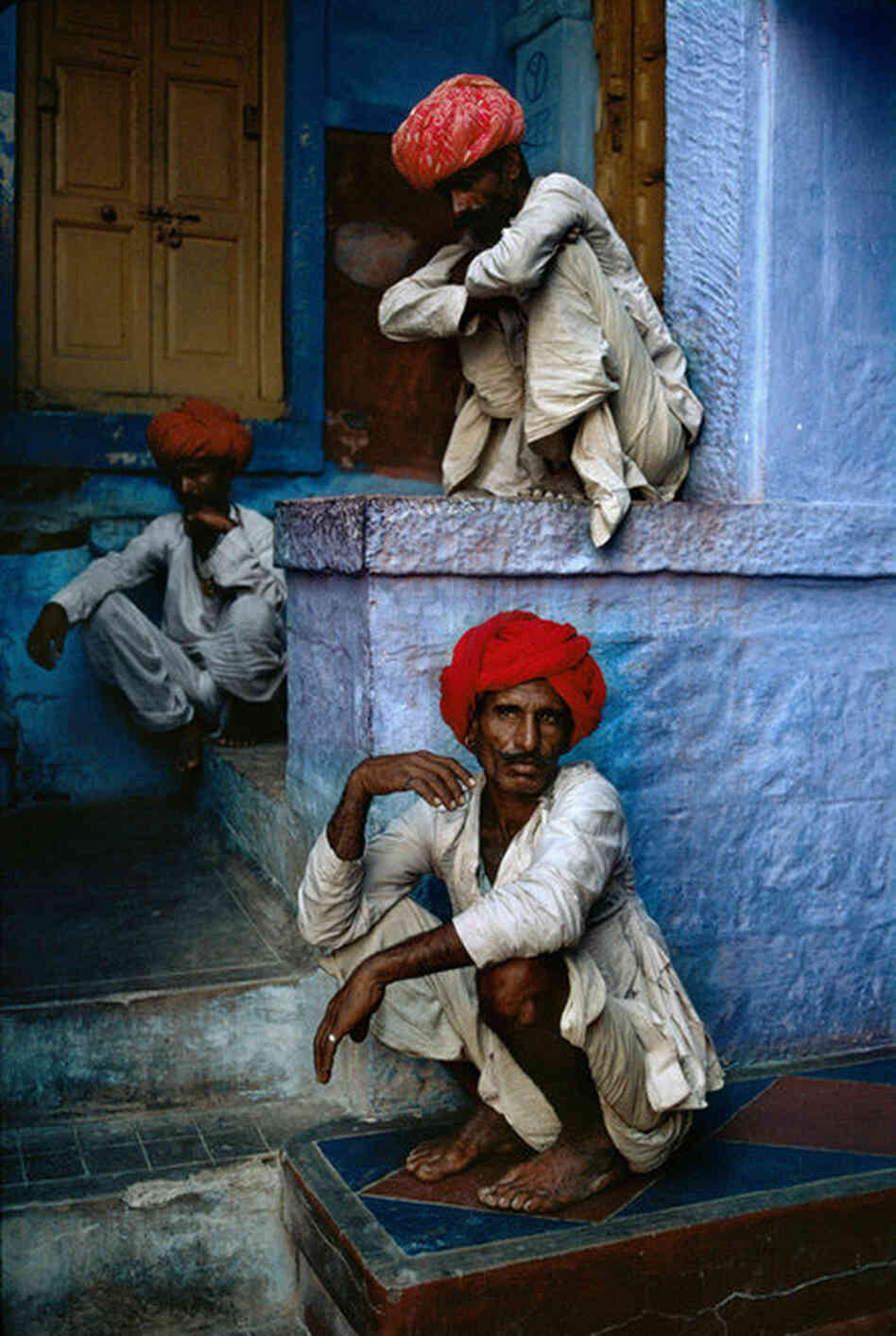 Three men sit in the old quarter in Jodhpur, India, 1996