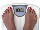 woman on a bathroom scale woman on a bathroom scale