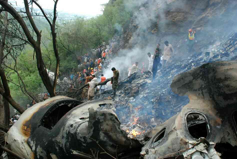 Pakistani rescue workers search the wreckage of a crashed passenger plane in the Margalla Hills on the outskirts of Islamabad on Wednesday. All 152 people on board were killed. 