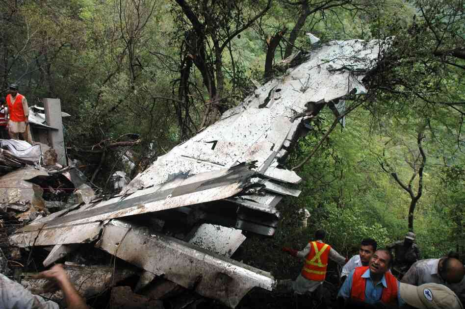 Pakistani rescuers surround the wreckage. 